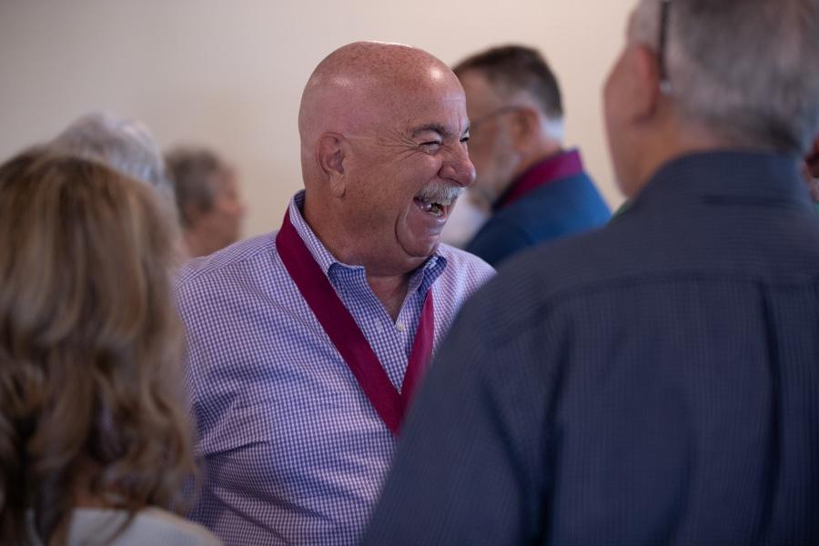 Alumni laugh together at event